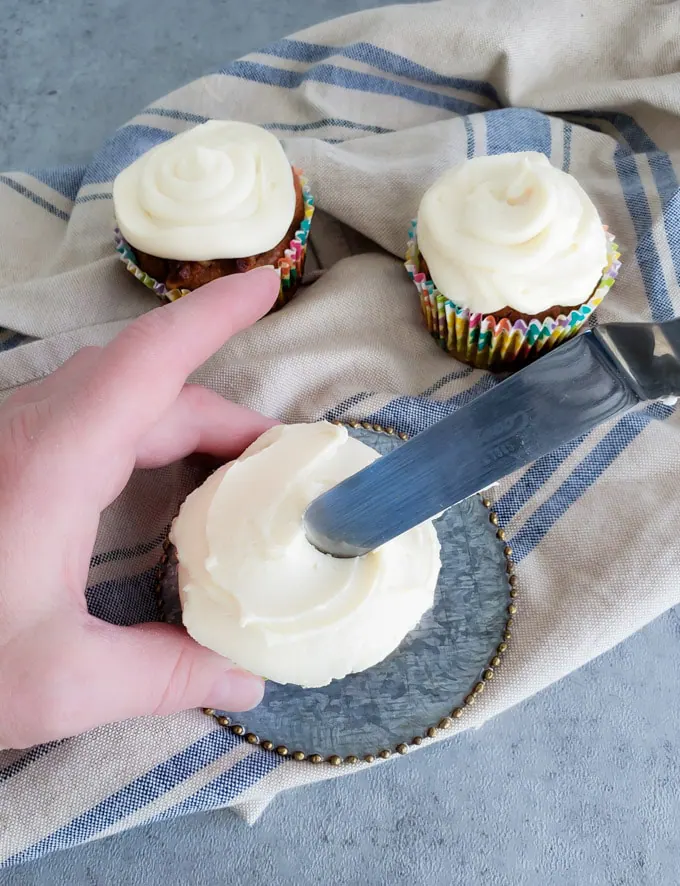 Muffin swirled with cream cheese frosting.