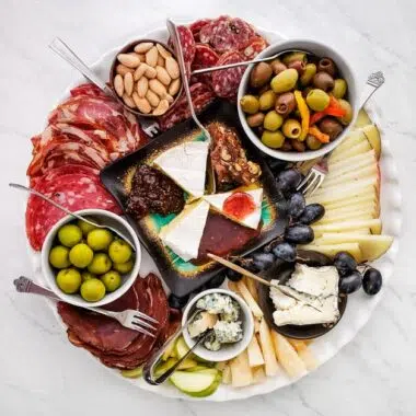 meat and cheese on a ceramic platter