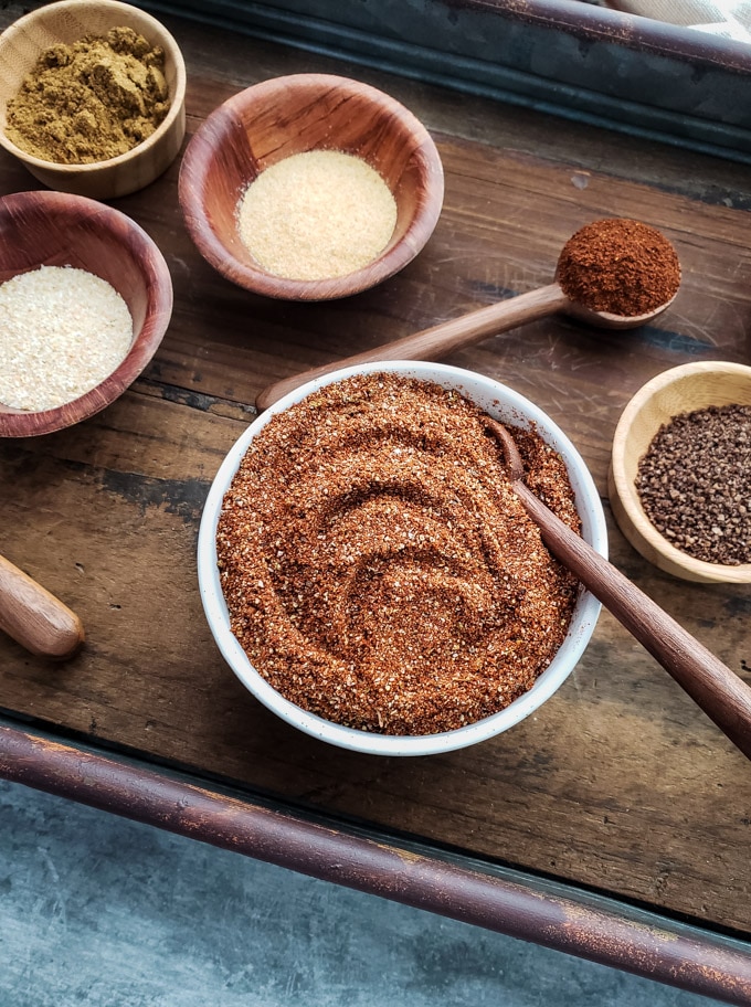 Dried spices in individual cups on serving tray.