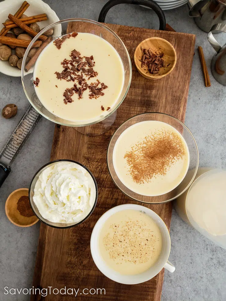 Custard eggnog served with whipped cream, nutmeg, cinnamon, and chocolate shavings.