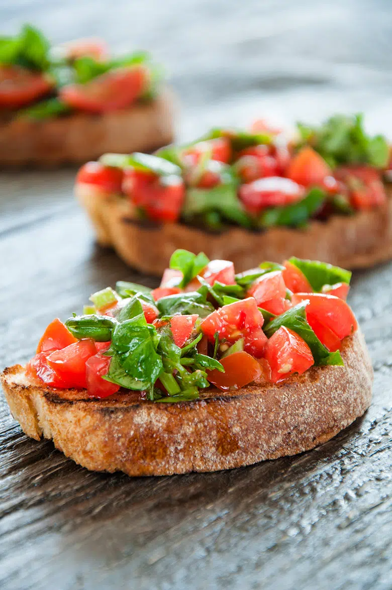 bread with tomatoes and basil on top