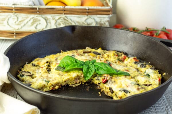 Frittata in a skillet with basil