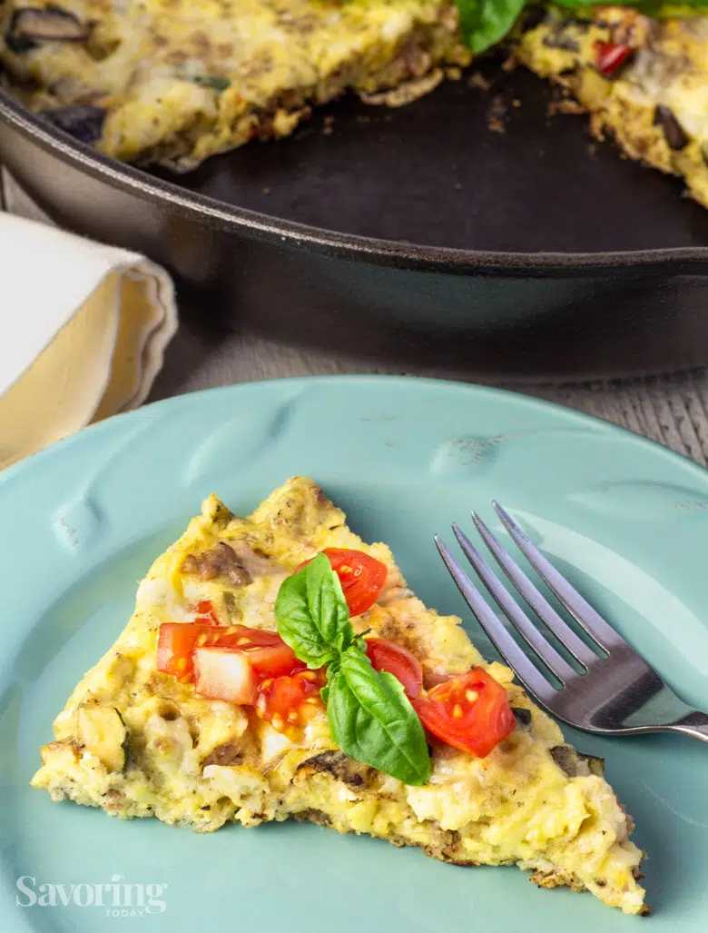 fluffy frittata with tomato and basil on top