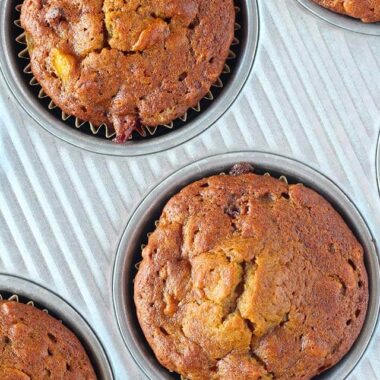 muffins with pumpkin and apple in a muffin tin