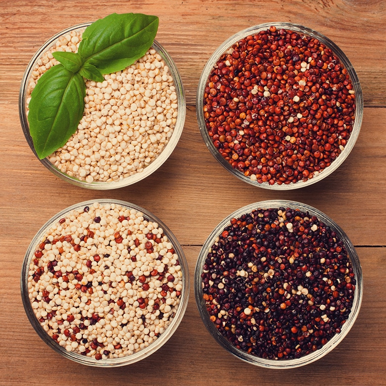 different colors of quinoa in four bowls