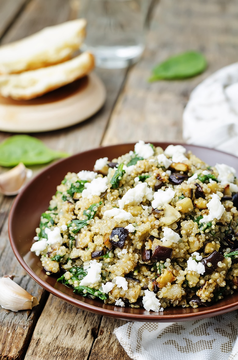 quinoa with eggplant, spinach and feta in a bowl