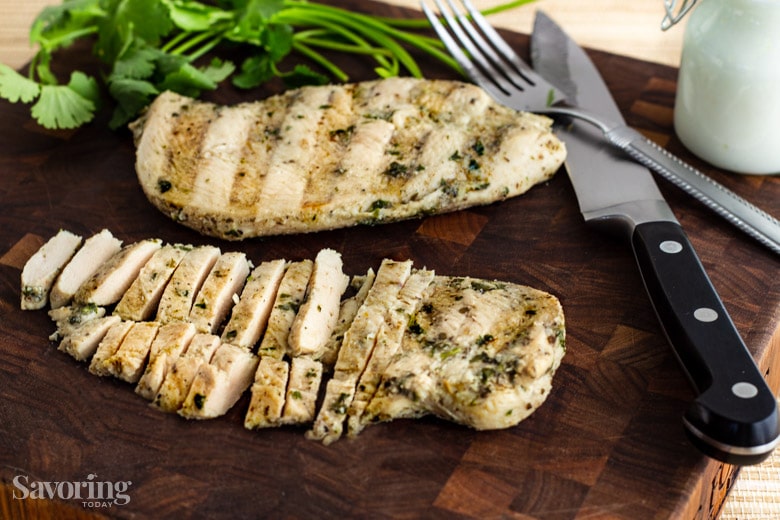 sliced grilled chicken on a cutting board