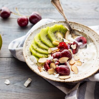 bowl of yogurt with fresh cherries and kiwi