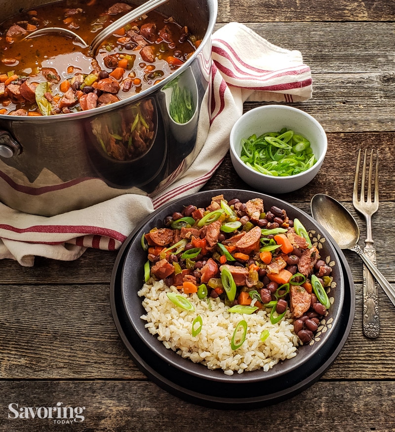 red beans with brown rice in a dark bowl on a wood table