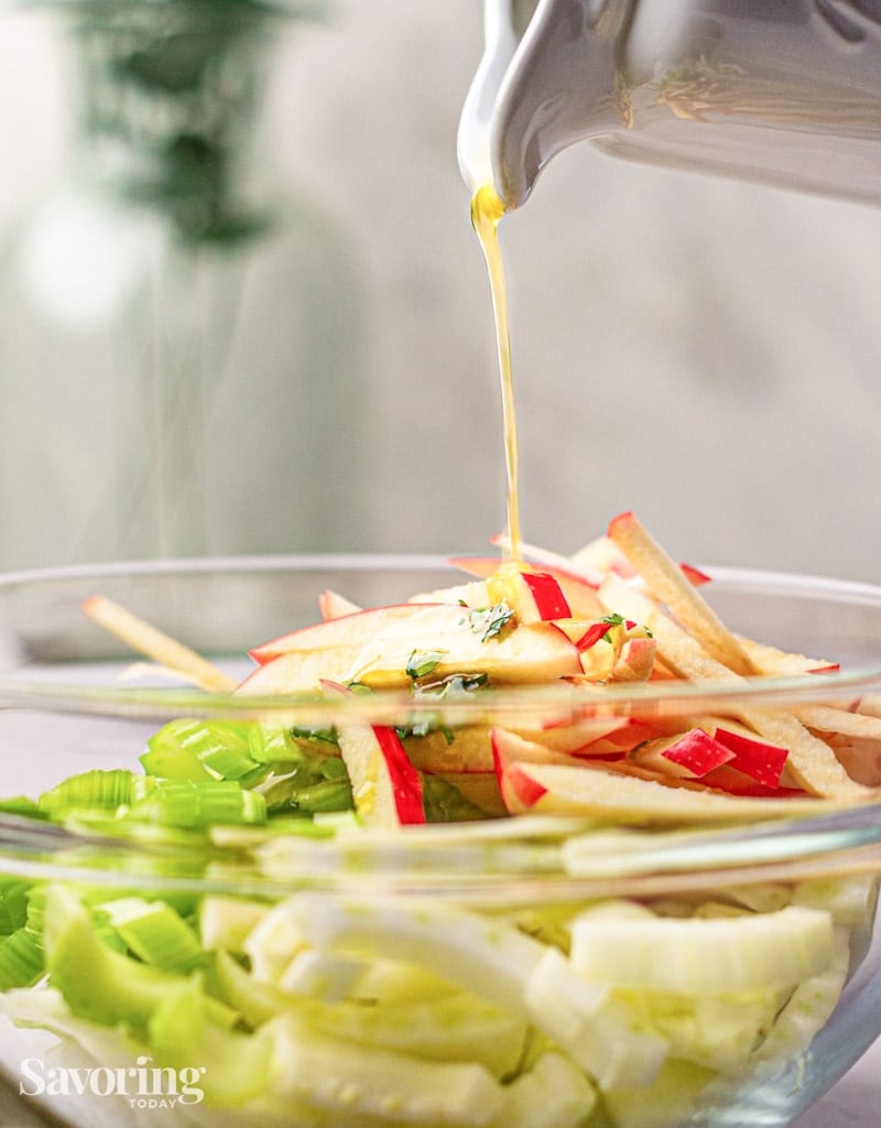 pouring dressing over slaw