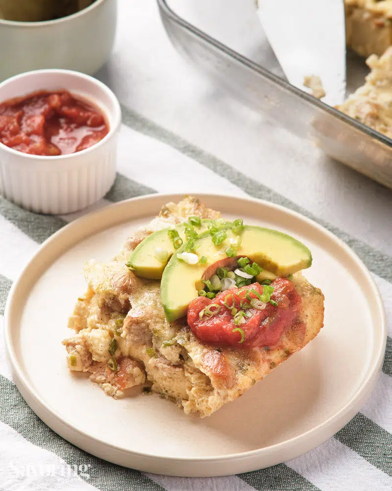 breakfast casserole served with avocado and salsa