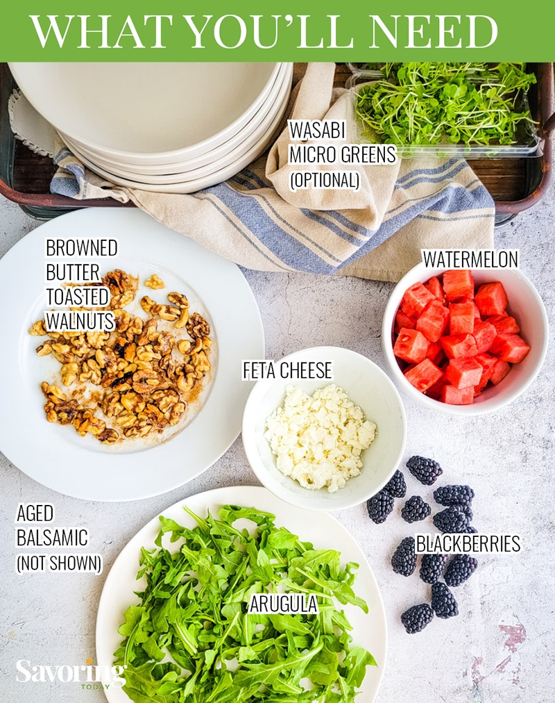 Ingredients for an arugula and watermelon salad on a stone background