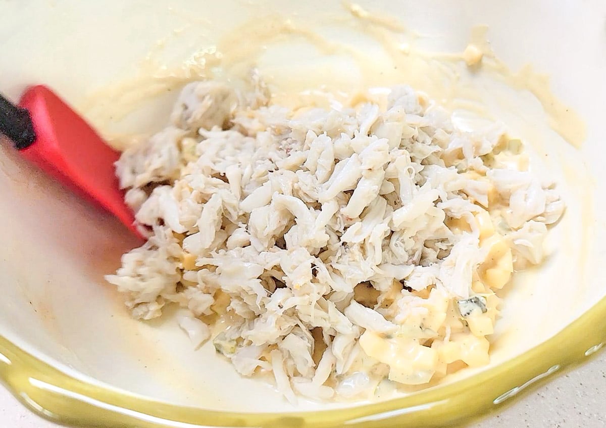 Mixing crab meat into mayo and spices