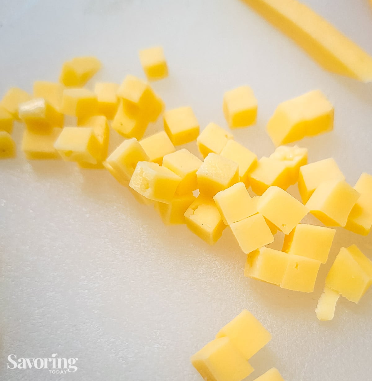 cubed gouda cheese on a cutting board
