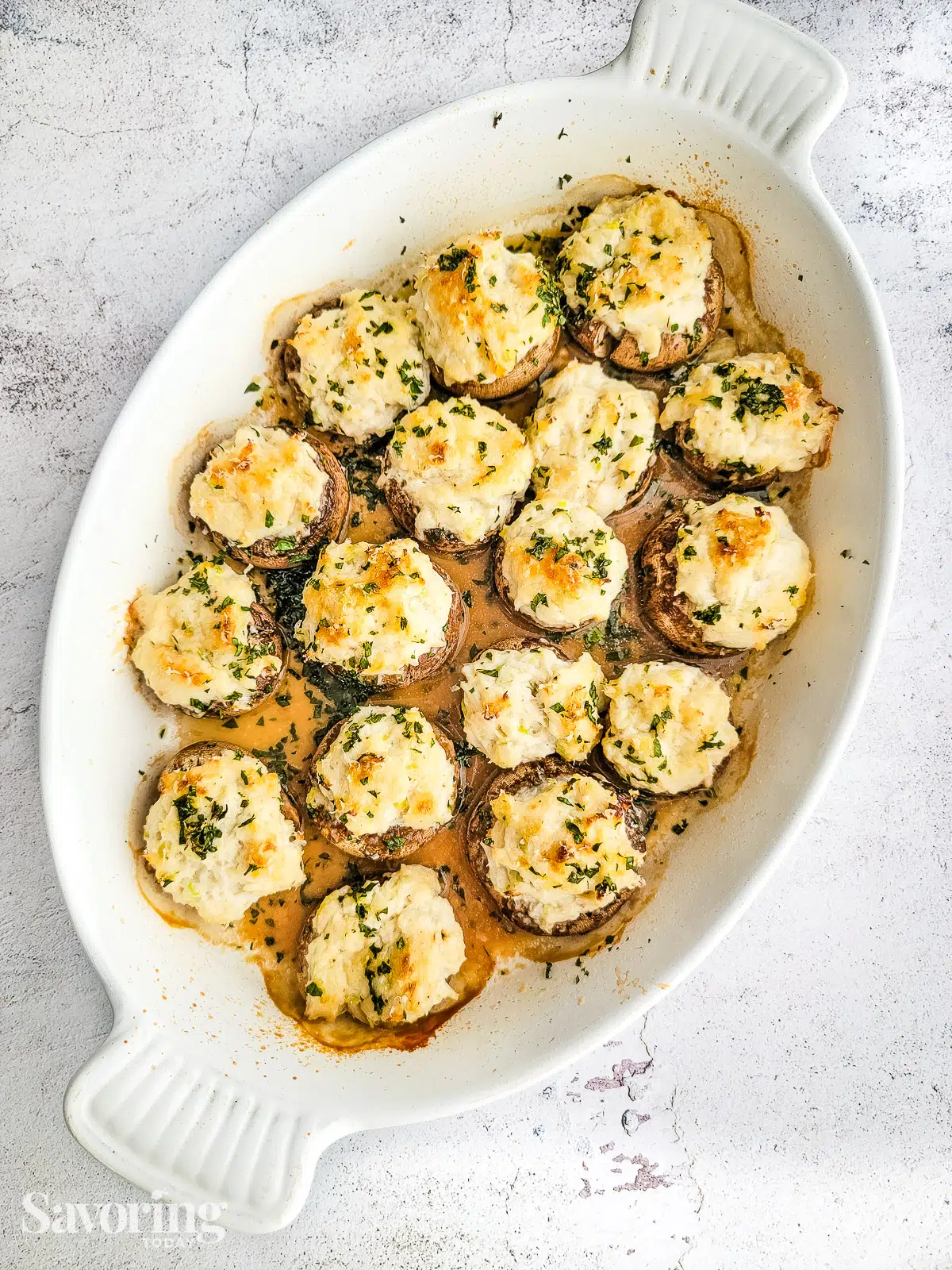 Mushrooms stuffed with crab fresh from the oven in a white dish