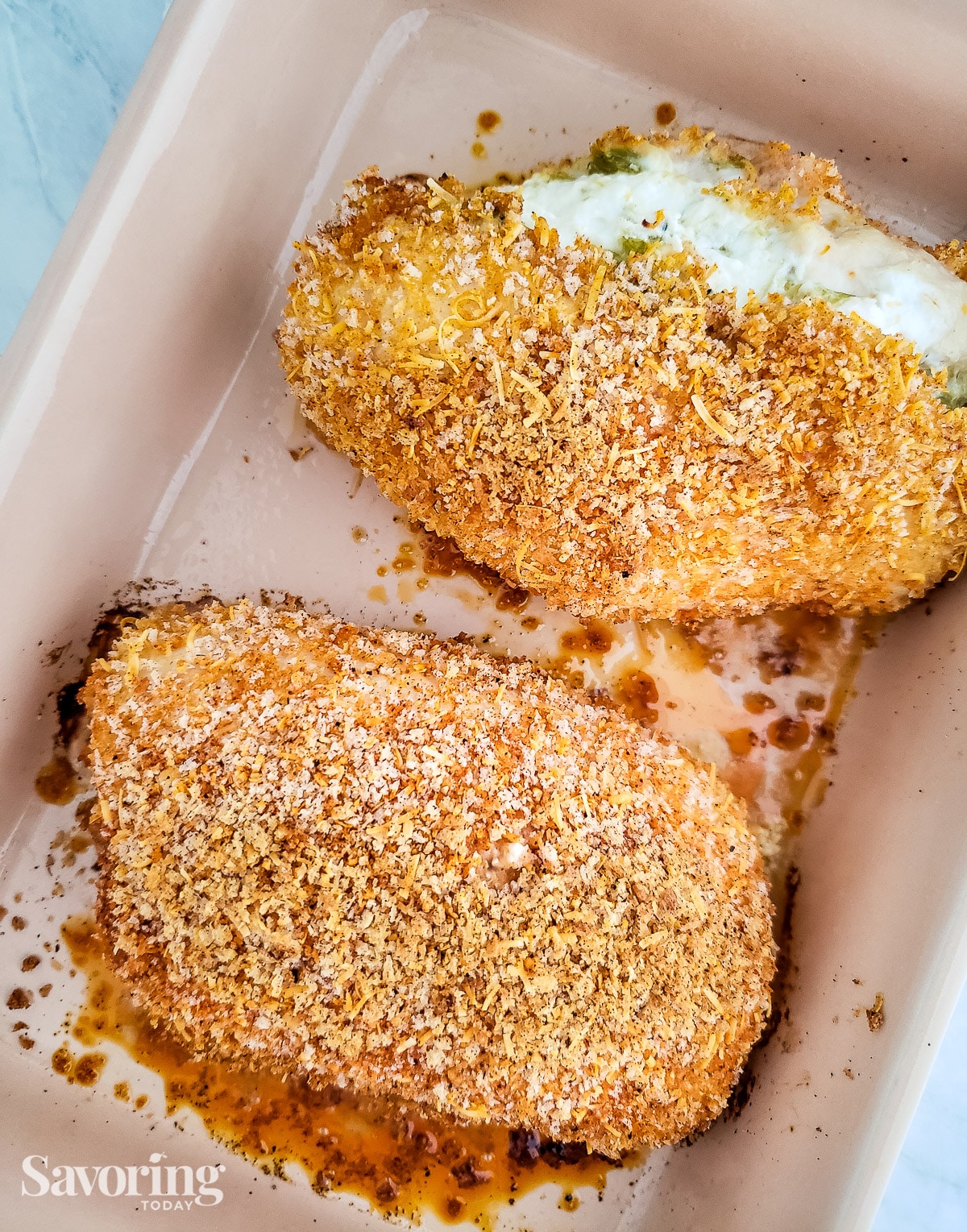 goat cheese stuffed chicken breasts in a baking dish