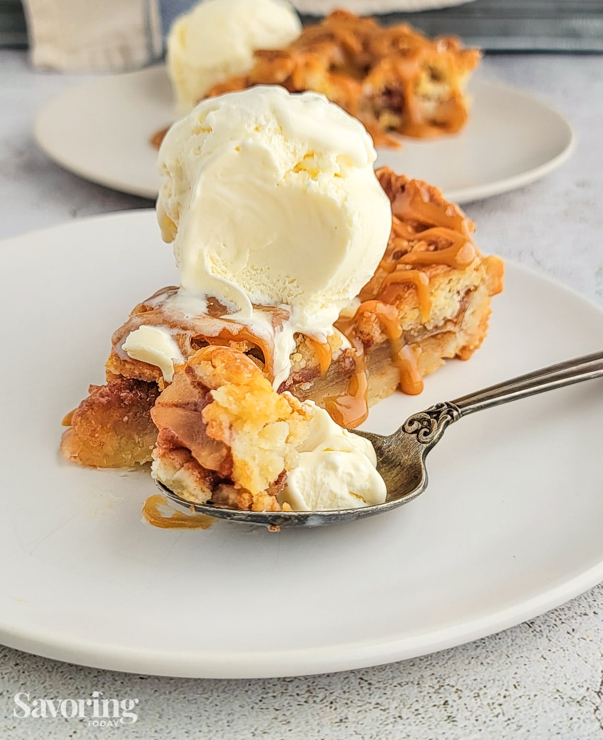 a bite of pie on a spoon with vanilla ice cream