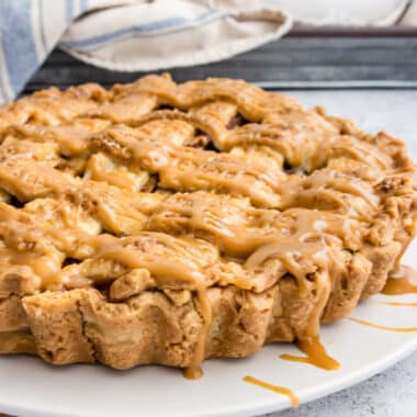 Apple tart with caramel sauce on a plate - tart pan side removed