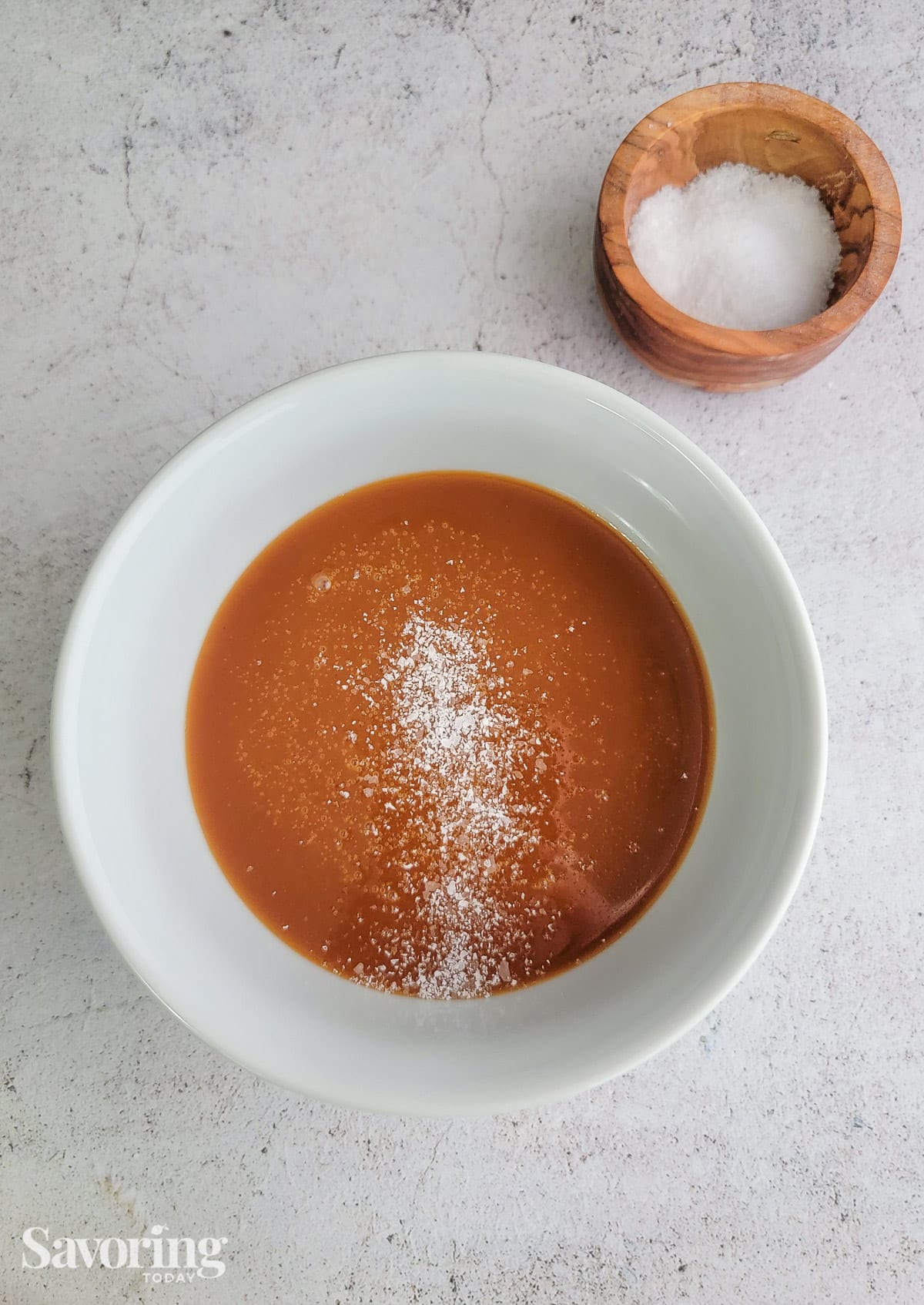 Salting the caramel in a white bowl