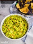 guacamole and chips on a table