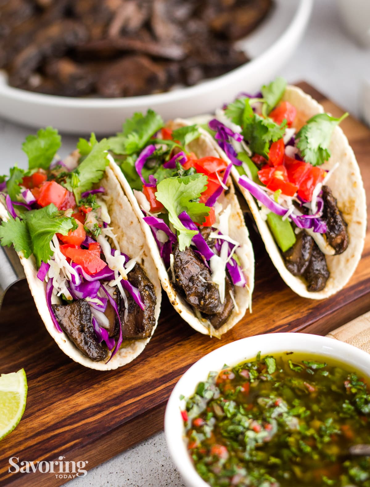 mushroom tacos with chimichurri, cabbage, tomatoes and cilantro
