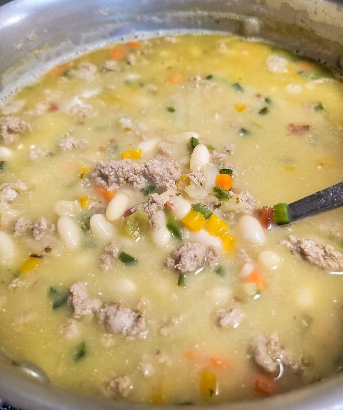 Stirring the cream into turkey chili 