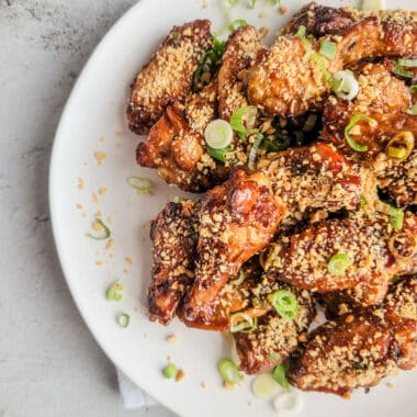 Kung Pao chicken wings dusted with peanuts and green onions