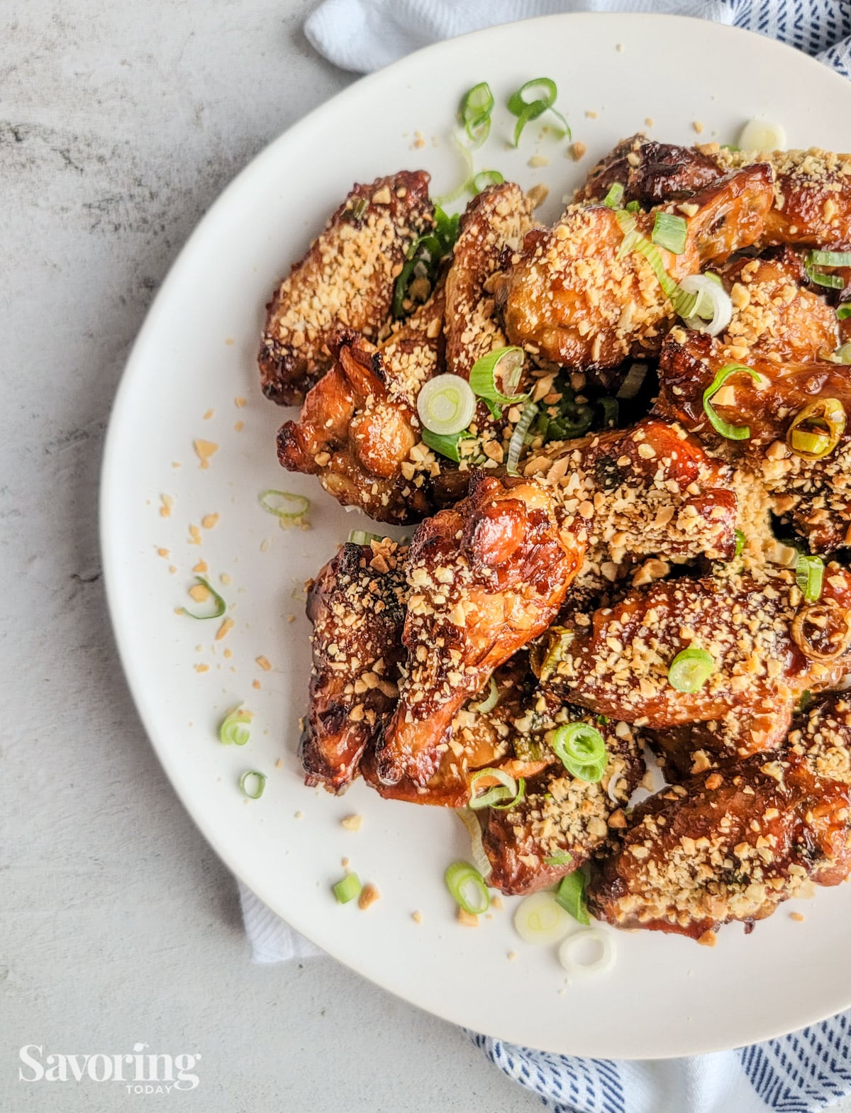 Kung Pao chicken wings dusted with peanuts and green onions