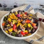 oven roasted vegetables with herbs in a bowl on a towel