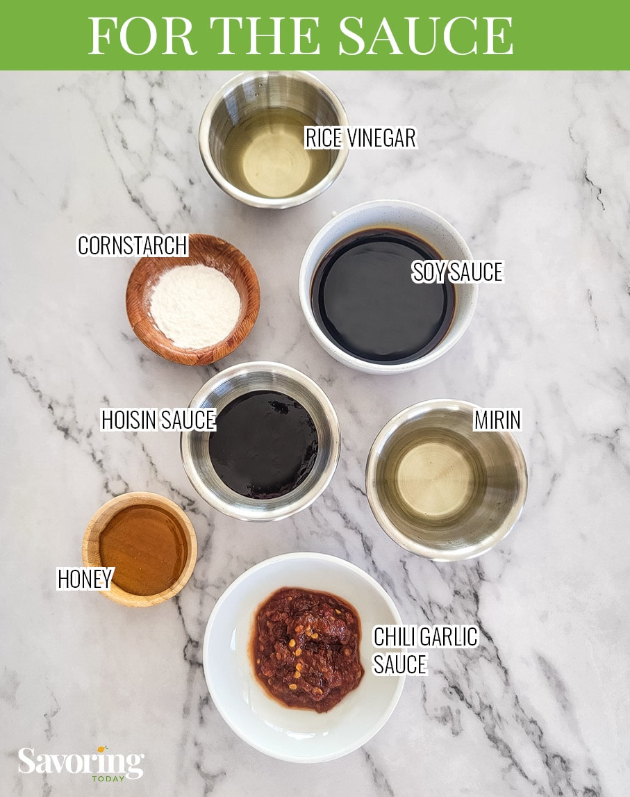 Sauce ingredients in small bowls on a counter with labels