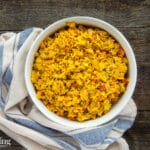 saffron rice with carrots in a bowl on a table