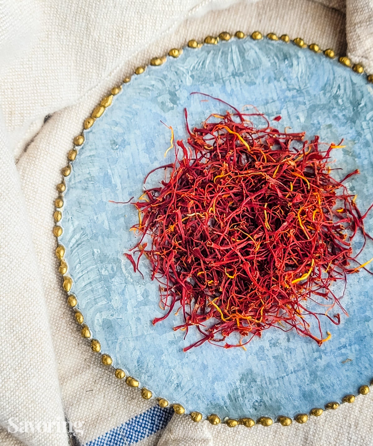 saffron threads on a blue saucer