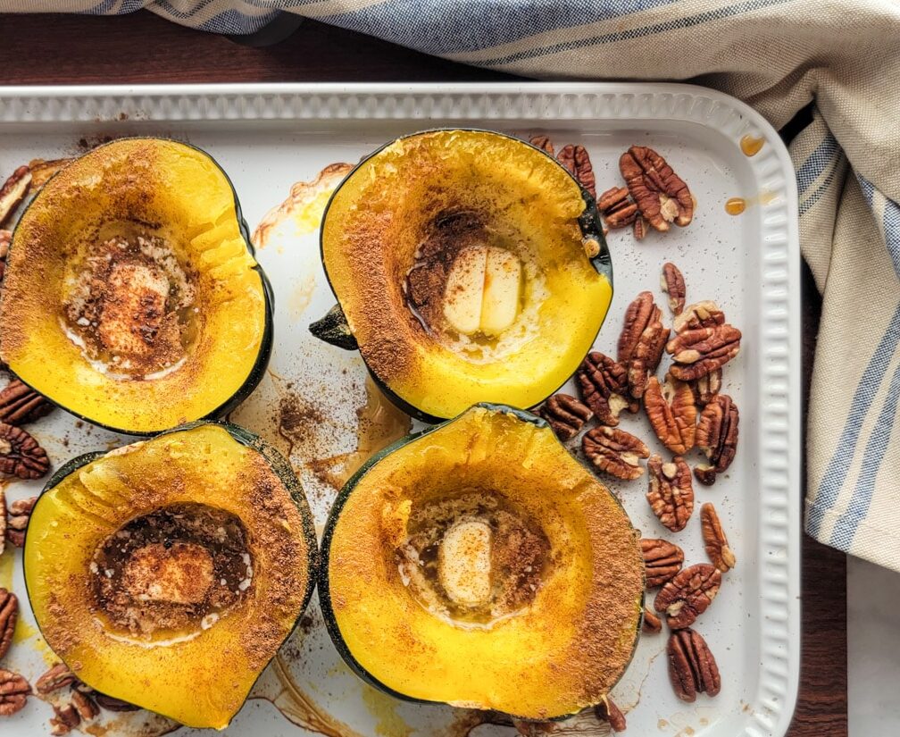 Roasted squash with butter, cinnamon, syrup, and pecans ready for the oven.