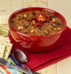 beef and bean chili in a red bowl with saltine crackers