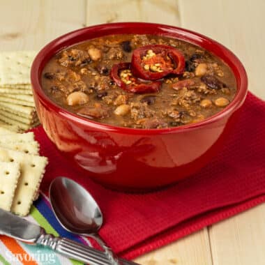 beef and bean chili in a red bowl with saltine crackers