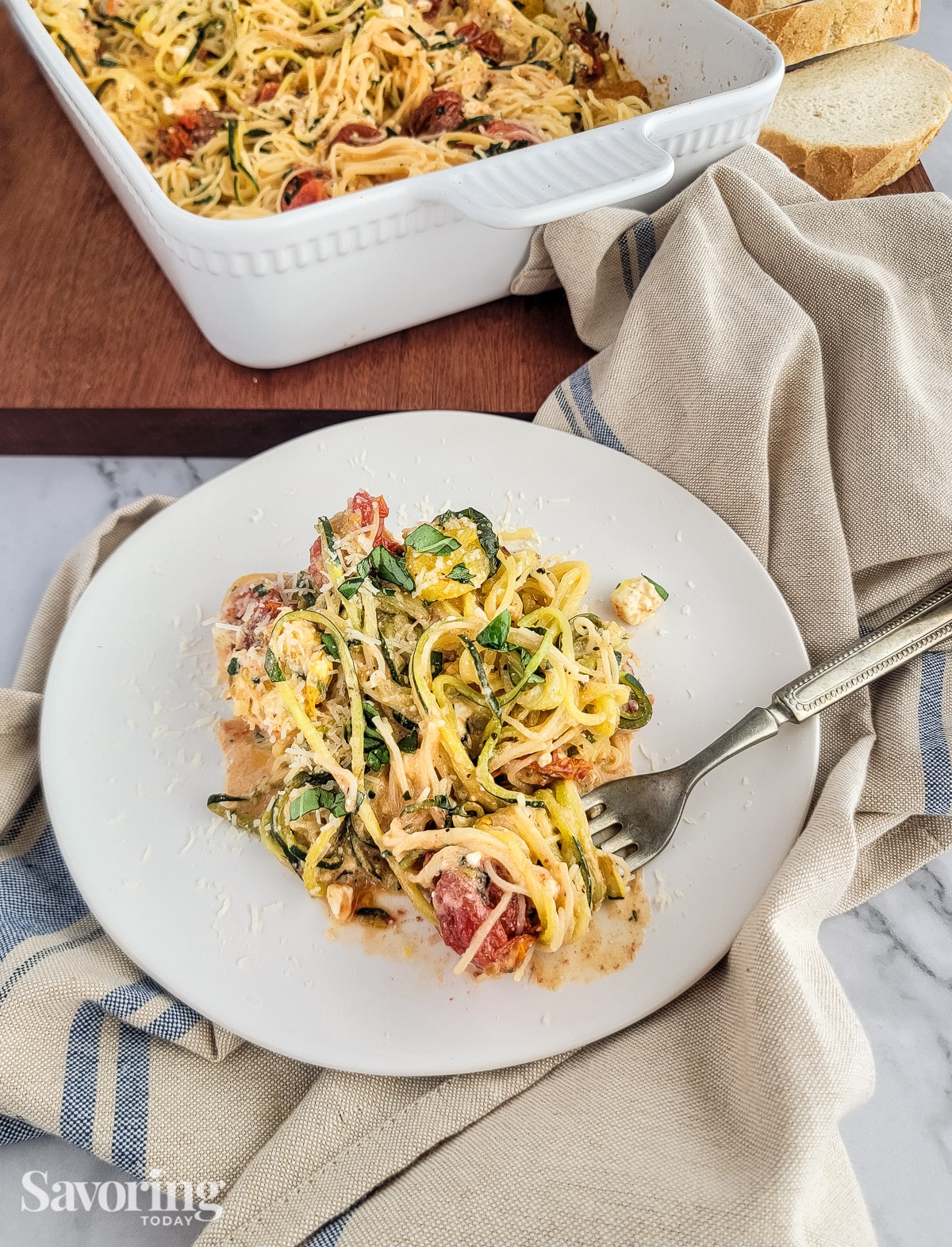 zucchini noodles and angel hair pasta bake twirled on a fork on a plate
