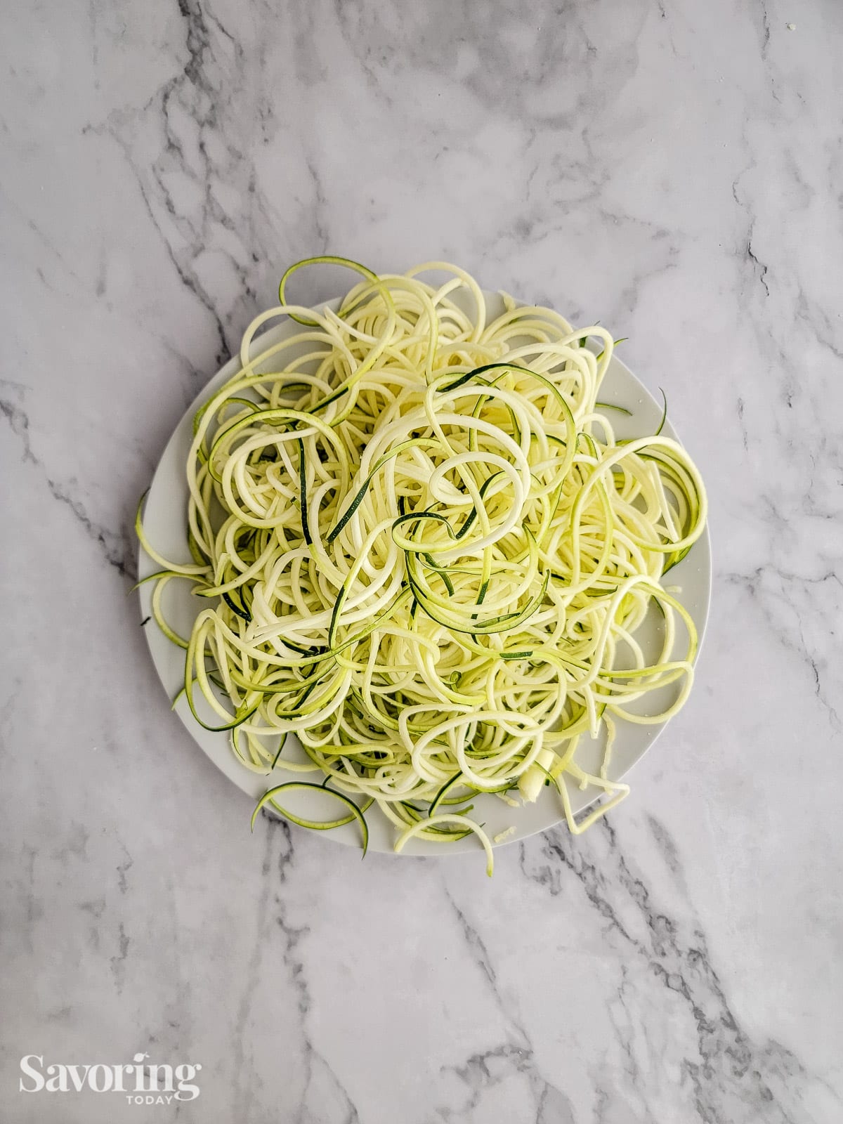 spiralized zucchini noodles on white plate