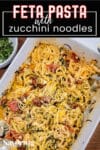 baked feta pasta with zucchini in a white dish with pinterest banner