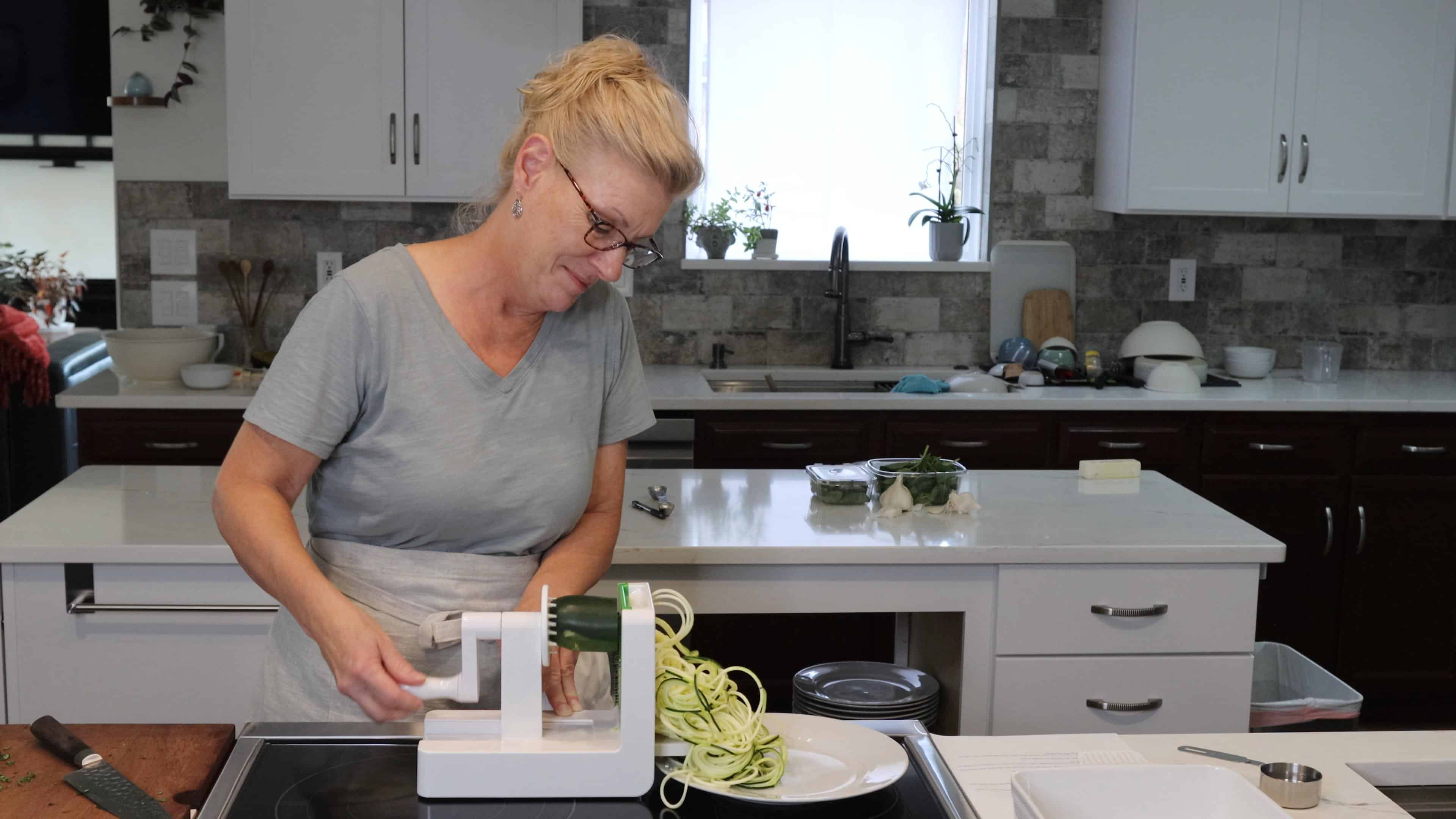 Judy making zucchini noodles with a spiralizer