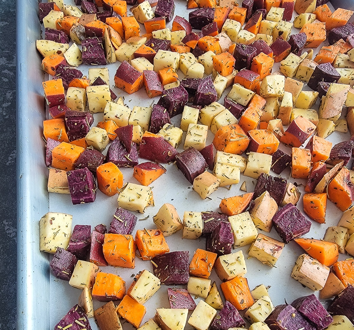 cubed sweet potatoes on a pan for roasting