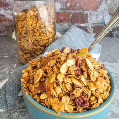 granola in a blue bowl on a grey counter