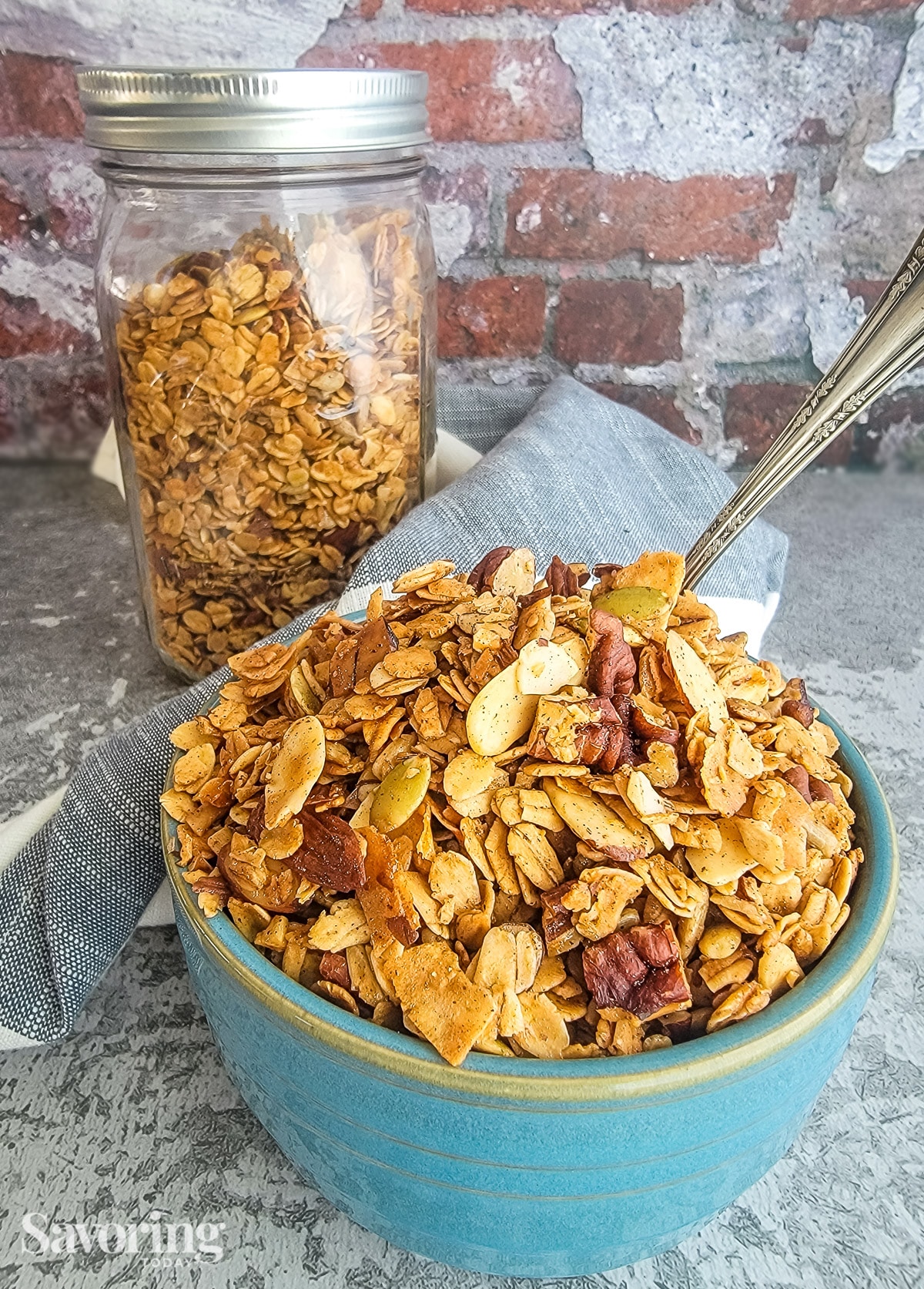 granola in a blue bowl on a grey counter