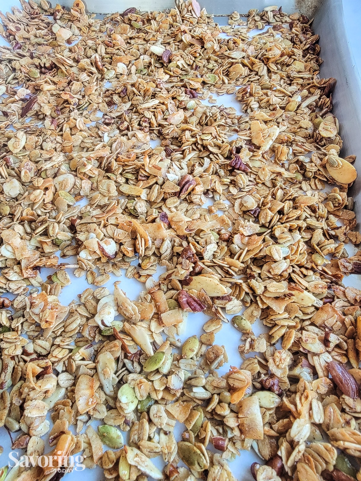 Granola spread on baking pan ready for the oven