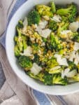 broccoli, parmesan, and pistachios tossed together in a serving bowl