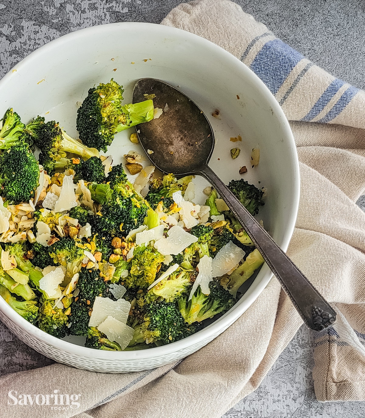 Roaste broccoli in a serving bowl with a spoon