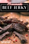 beef jerky on a cutting board with pinterest banner