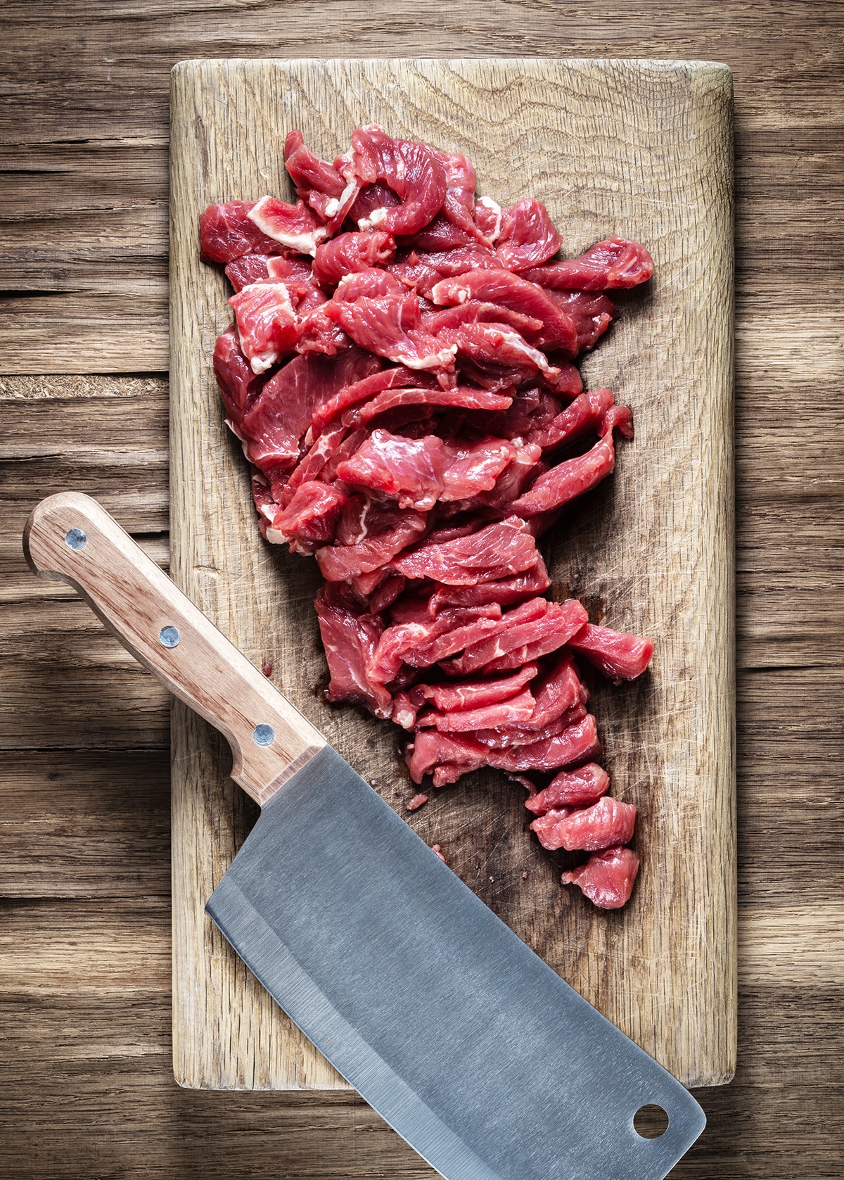 Beef cut into thin strips on a cutting board