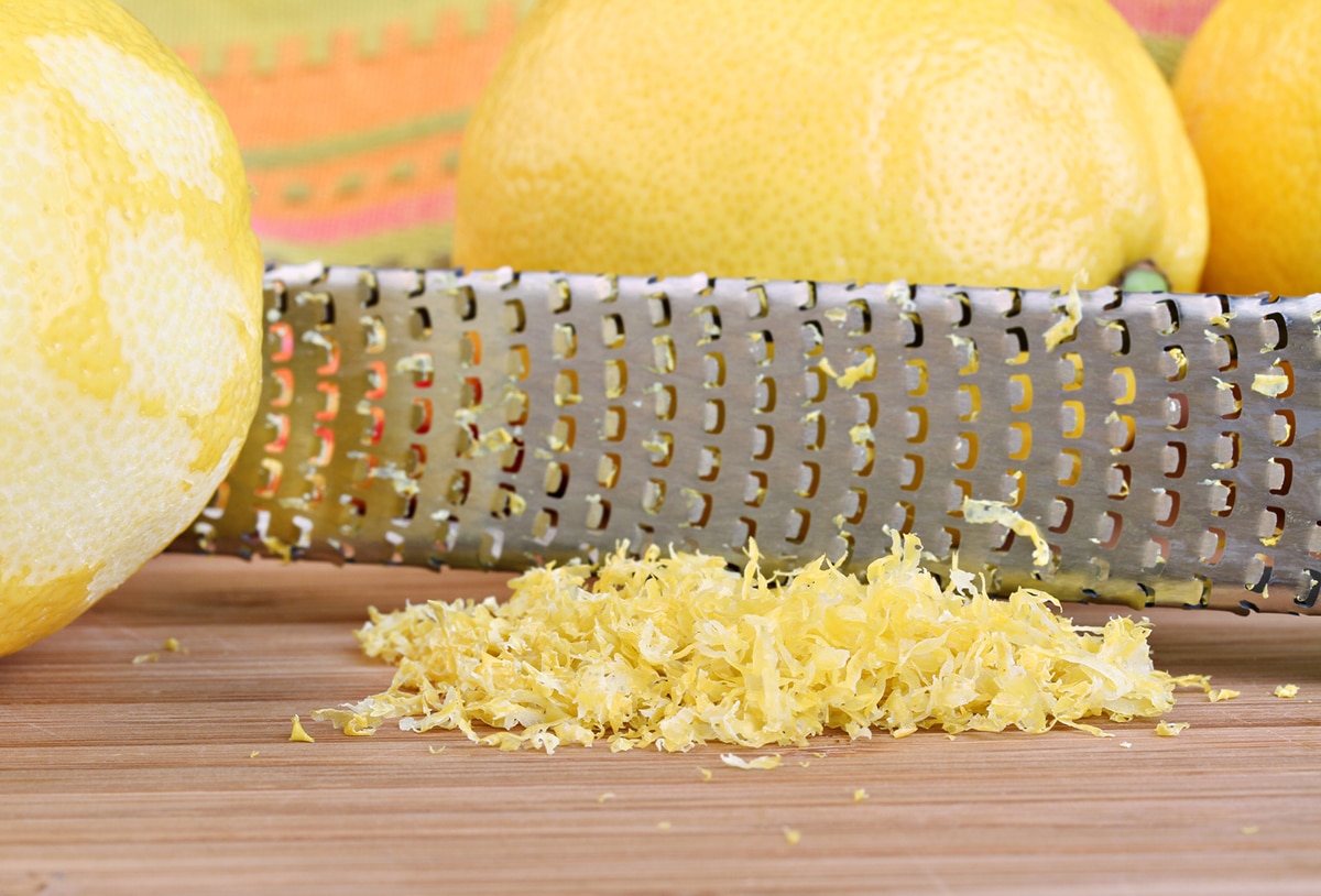 lemon zest on a cutting board by a microplane zester