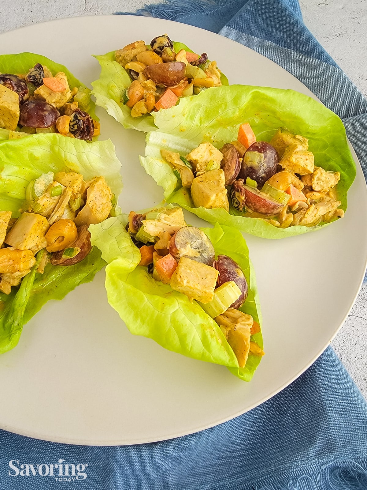 curry chicken salad in lettuce cups on a white platter