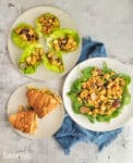 chicken salad on lettuce cups, on salad, and also shown on a croissant all on plates